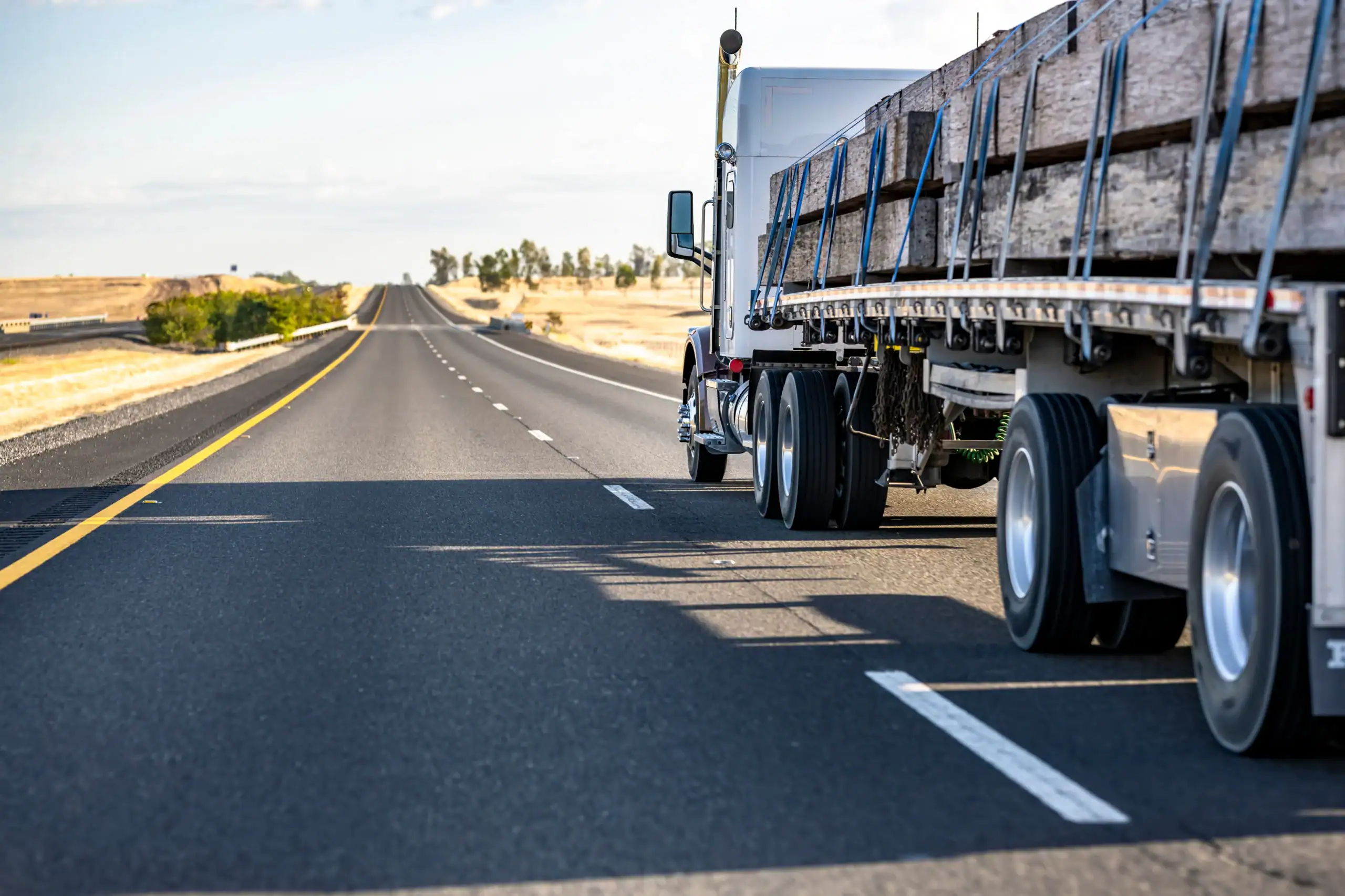Semi-truck hauling cargo on a clear Texas highway.